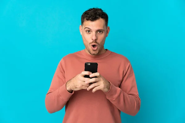 Young Caucasian Handsome Man Isolated Blue Background Looking Camera While — Stock Photo, Image