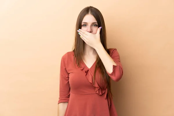 Mulher Branca Jovem Isolado Fundo Bege Cobrindo Boca Com Mão — Fotografia de Stock