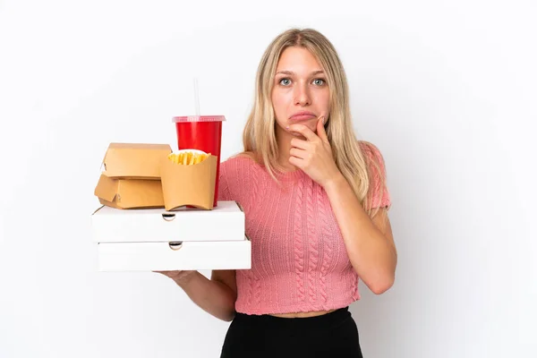 Young Caucasian Woman Holding Fat Food Isolated Blue Background Thinking — Stock Photo, Image