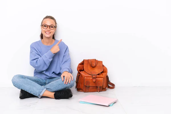 Giovane Studentessa Seduta Uno Pavimento Isolato Sfondo Bianco Che Punta — Foto Stock