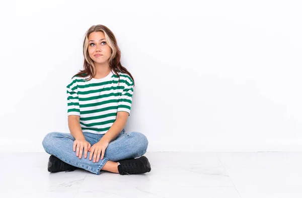 Young Russian Girl Sitting Floor Isolated White Background Looking — Stock Photo, Image