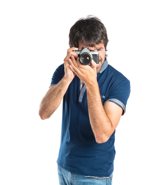 Homem fotografando sobre fundo branco — Fotografia de Stock