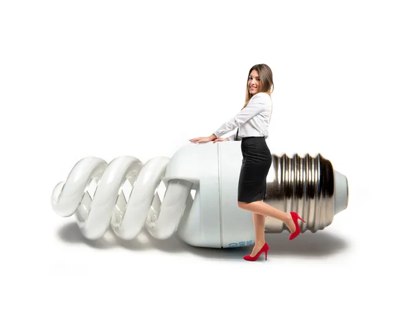 Business woman with bulb over white — Stock Photo, Image