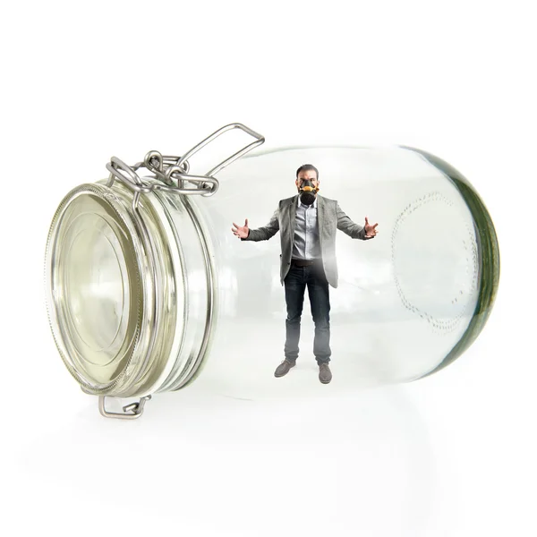 Businessman with gas mask inside glass jar — Stock Photo, Image