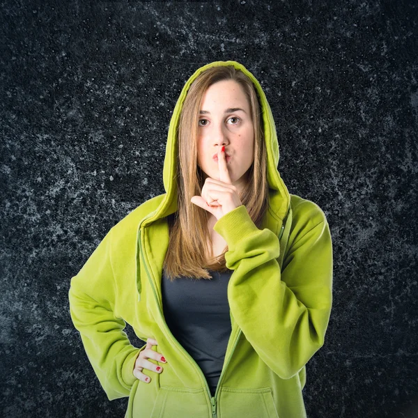 Young girl making silence gesture over black background — Stock Photo, Image