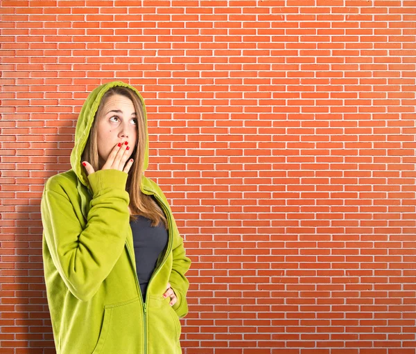 Girl doing surprise gesture over textured background — Stock Photo, Image