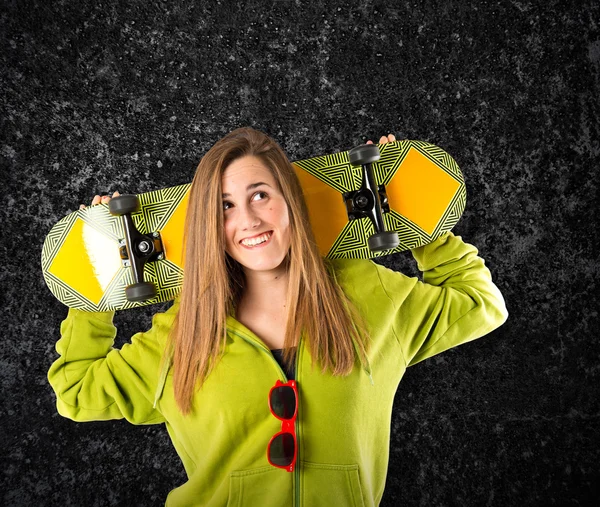 Skater with green sweatshirt over black background — Stock Photo, Image