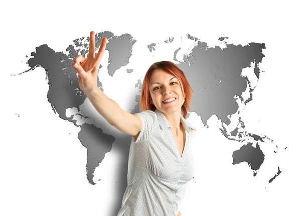 Young woman doing victory gesture over map background — Stock Photo, Image