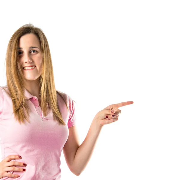 Girl pointing to the lateral over white background — Stock Photo, Image