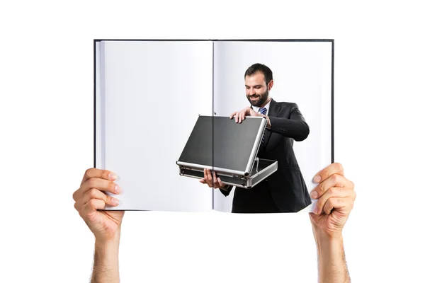 Young businessman open his briefcase printed on book — Stock Photo, Image