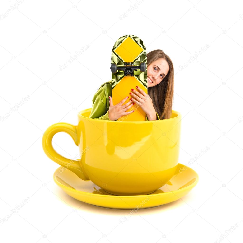 Pretty young girl inside cup of coffee