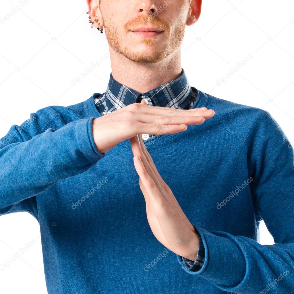 Man making time out gesture over white background 