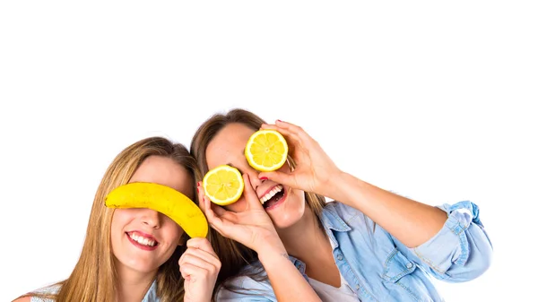 Friends playing with fruits over white background — Stock Photo, Image