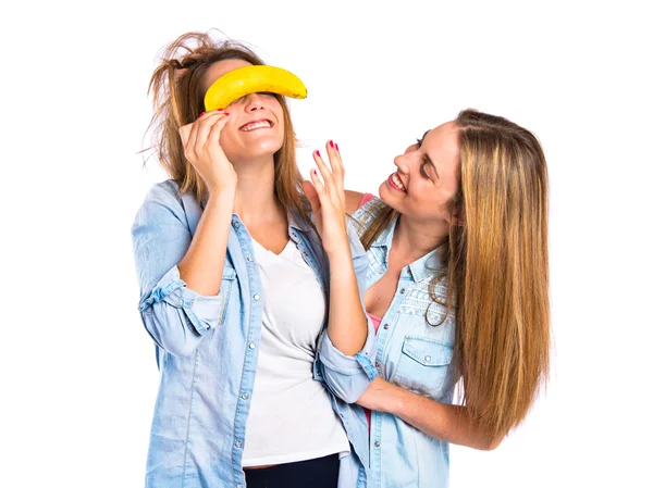 Friends playing with banana over white background — Stock Photo, Image