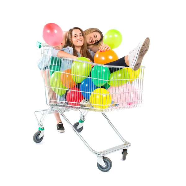 Přáteli, kteří hrají s balónky a supermarket vozíku — Stock fotografie