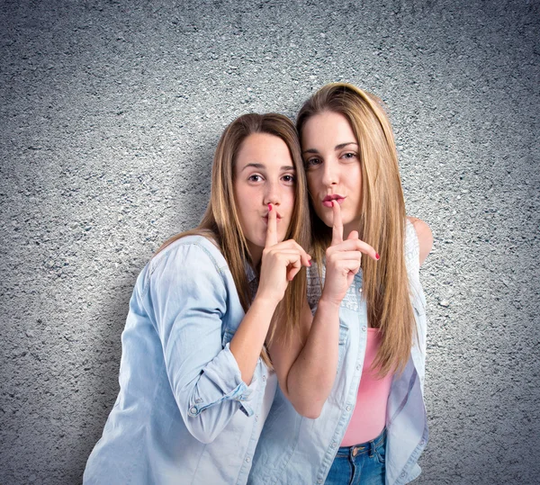 Friends making silence gesture over textured background — Stock Photo, Image