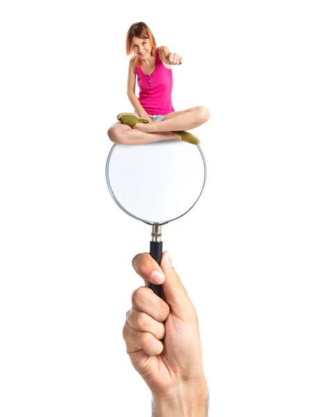 Pretty young girl with thumbs up on magnifying glass — Stock Photo, Image