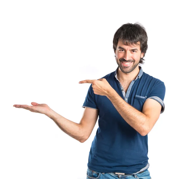 Man holding something over white background — Stockfoto