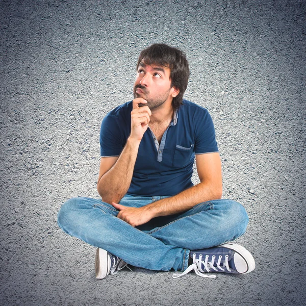 Man thinking over textured background — Stock Photo, Image