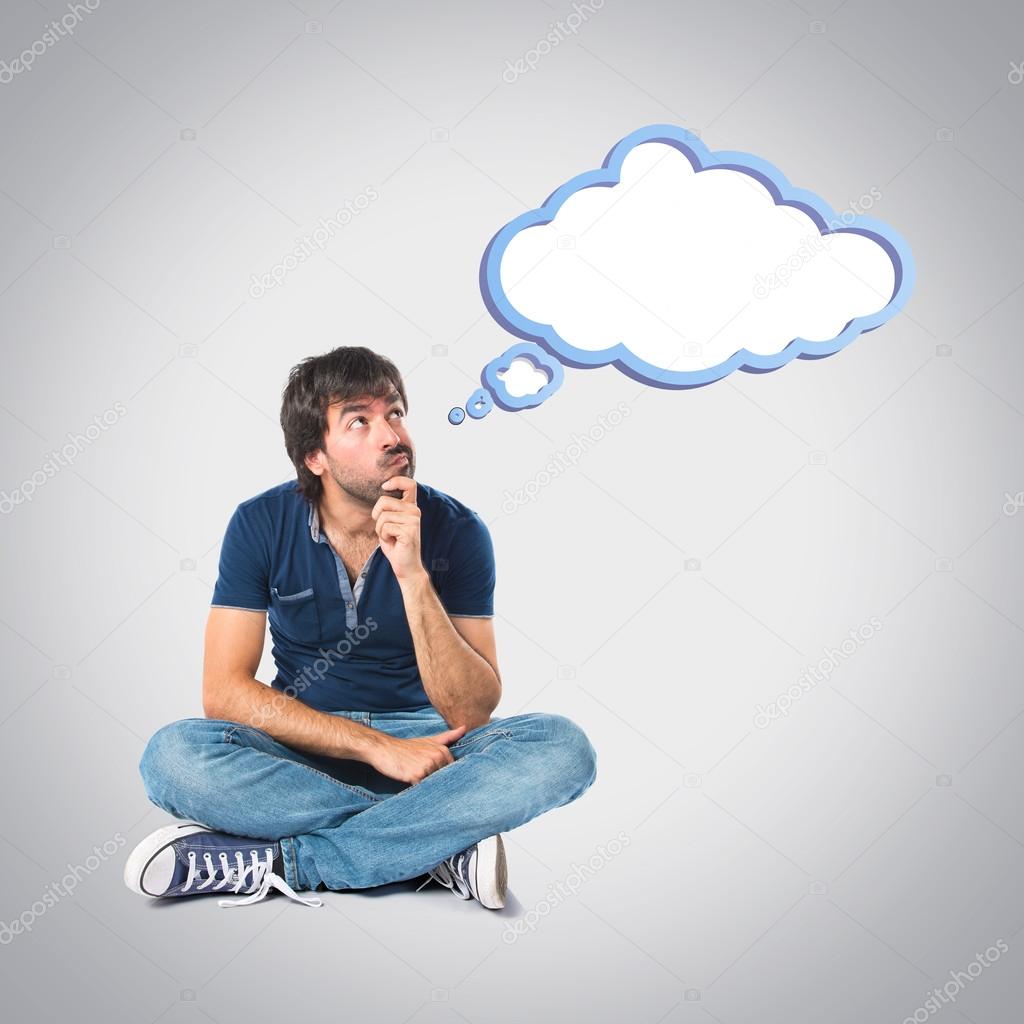 Man thinking over grey background