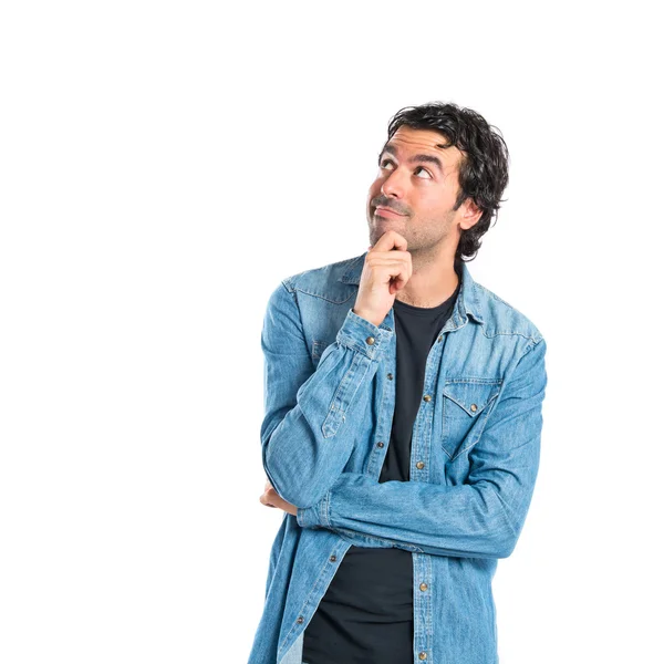 Brunette man thinking over isolated white background — Stock Photo, Image