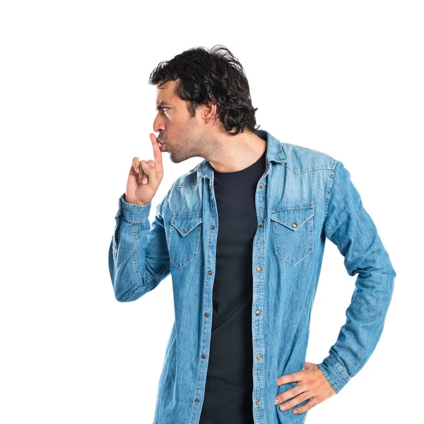 Man making silence gesture over isolated white background — Stock Photo, Image