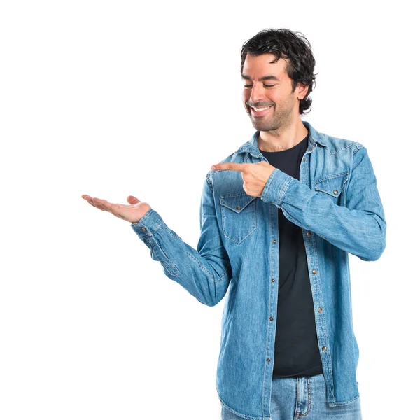Man holding something over white background — Stockfoto