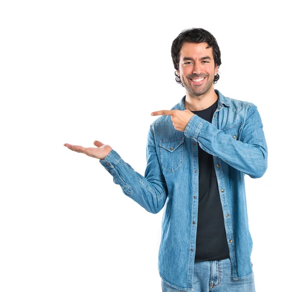 Man holding something over white background — Stock Photo, Image