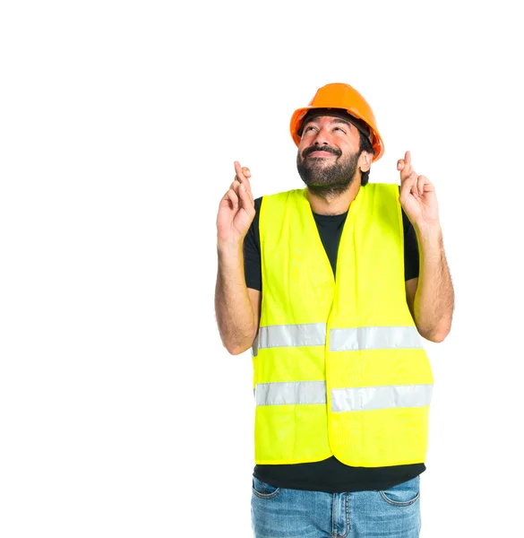 Workman met zijn vingers oversteken witte achtergrond — Stockfoto