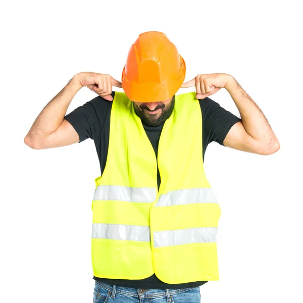 Workman covering his ears over white background — Stock Photo, Image