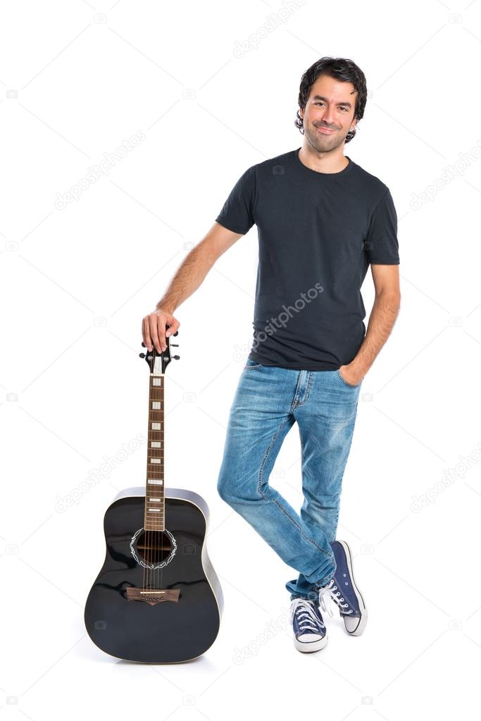 Handsome man with guitar over white background