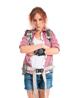 backpacker with her arms crossed over white background