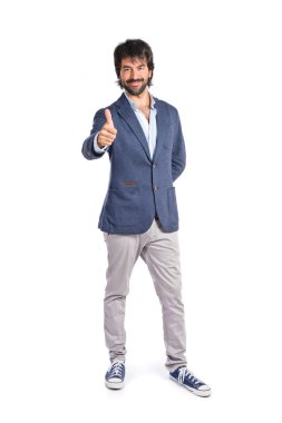 Beyaz arka plan üzerinde başparmak ile yakışıklı adam  