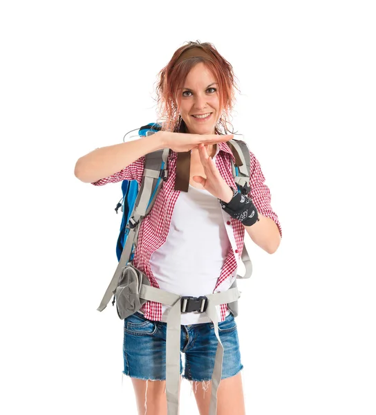 Backpacker making time out gesture over white background — Stockfoto