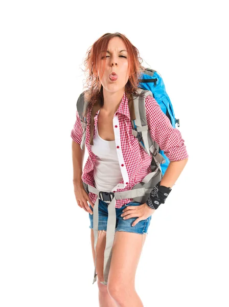 Backpacker doing a joke over isolated white background — ストック写真