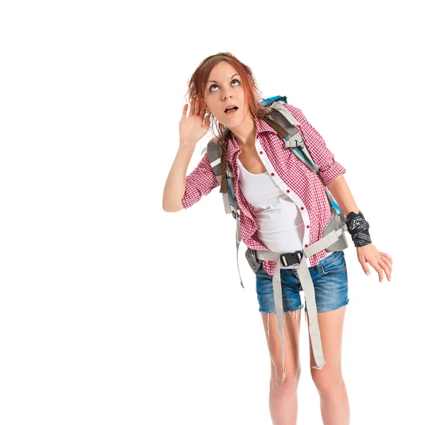 Backpacker listening over isolated white background — 图库照片