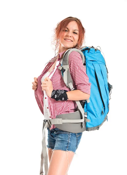Pretty backpacker over isolated white background — Stockfoto