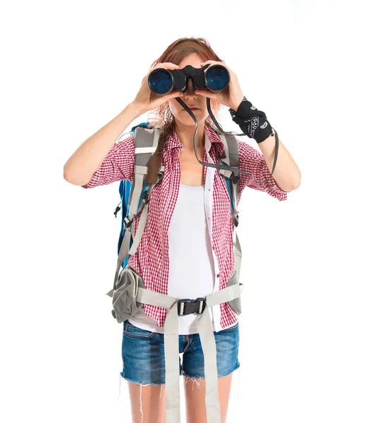 Girl looking through binoculars over white background — Stock Photo, Image