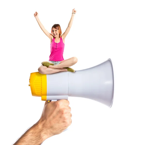 Lucky woman sitting on megaphone — Stock Photo, Image