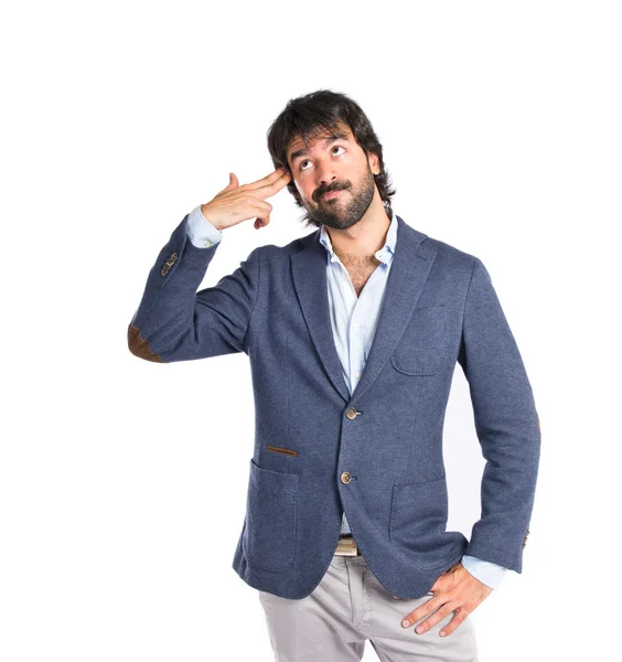 Handsome man making suicide gesture over white background — Stock Photo, Image