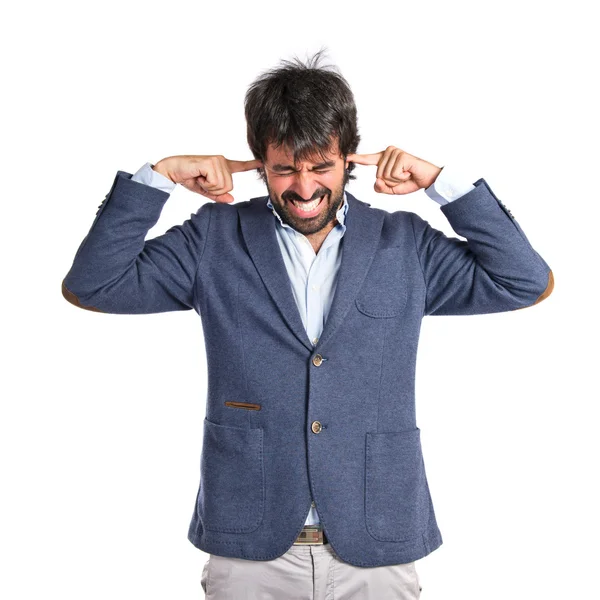 Man covering his ears over white background — Stock Photo, Image