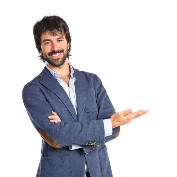 Businessman presenting something over isolated white background — Stock Photo, Image