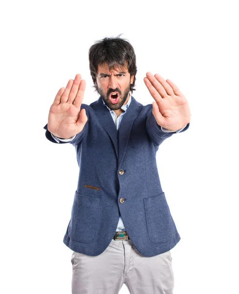 Hombre haciendo señal de stop sobre fondo blanco —  Fotos de Stock