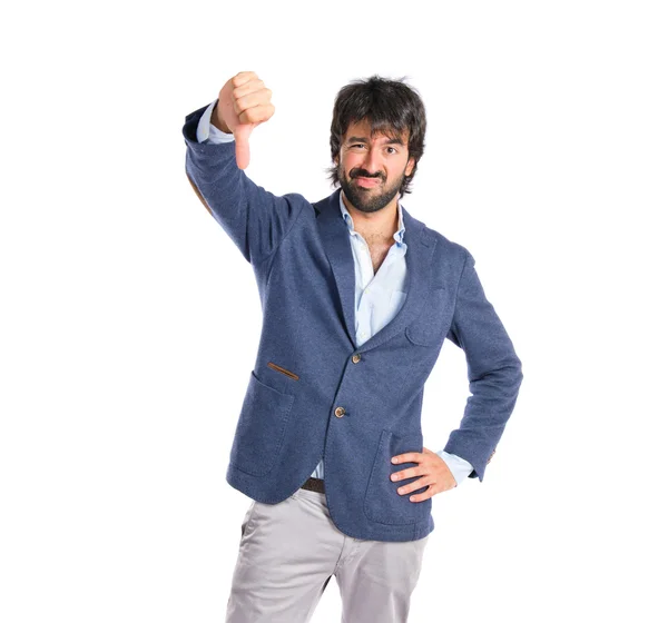 Businessman doing a bad signal over white background — Stock Photo, Image