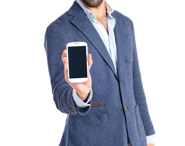 Brunetteman mostrando un móvil sobre fondo blanco —  Fotos de Stock