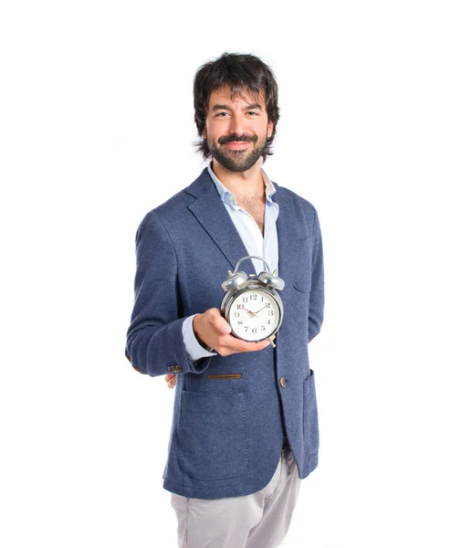 Empresário segurando um relógio sobre fundo branco — Fotografia de Stock