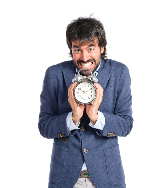 Geschäftsmann hält eine Uhr vor weißem Hintergrund — Stockfoto