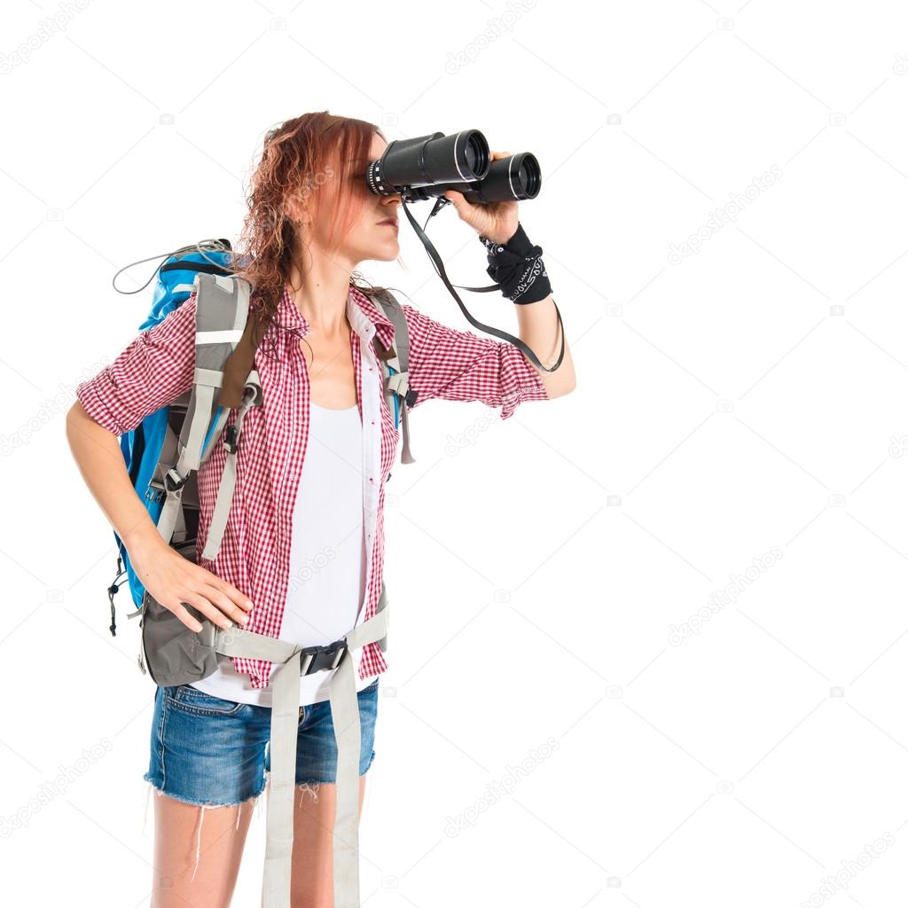 girl looking through binoculars over white background