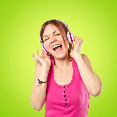 Genç kız üzerinde yeşil arka plan müzik dinleme 