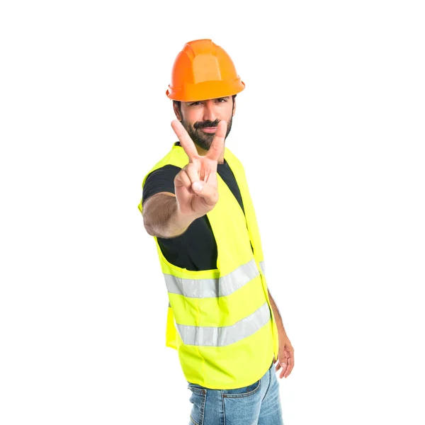 Workman gör seger gest över vit bakgrund — Stockfoto